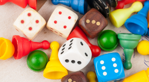 Image of game pieces and dice on a table