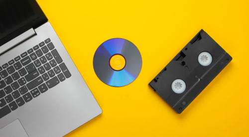 Image of laptop, DVD, and VHS cassette